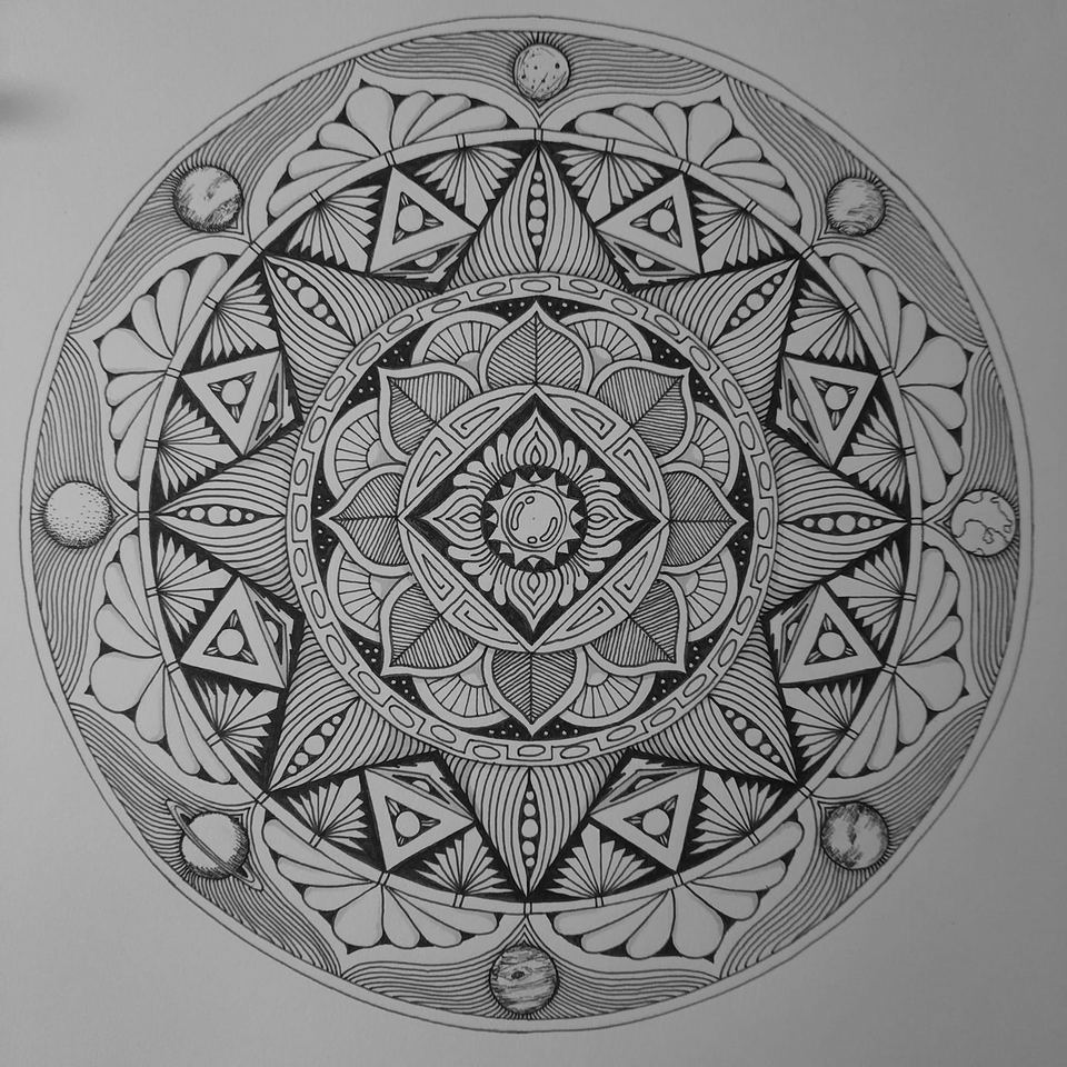 Pen-and-ink mandala ringed with small planets